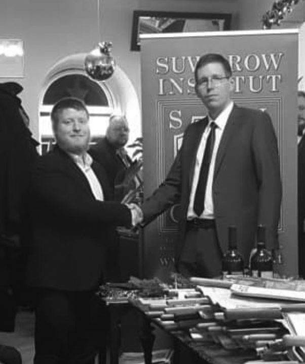 Patrick Poppel handing over the chairmanship to Alexander Markovics. Source: Suvorov Institute website